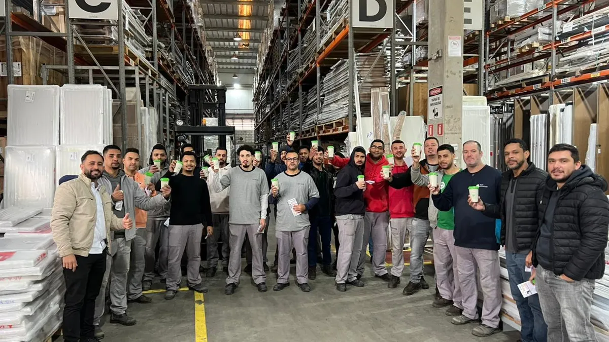 Colaboradores erguendo as mudas ao final do treinamento