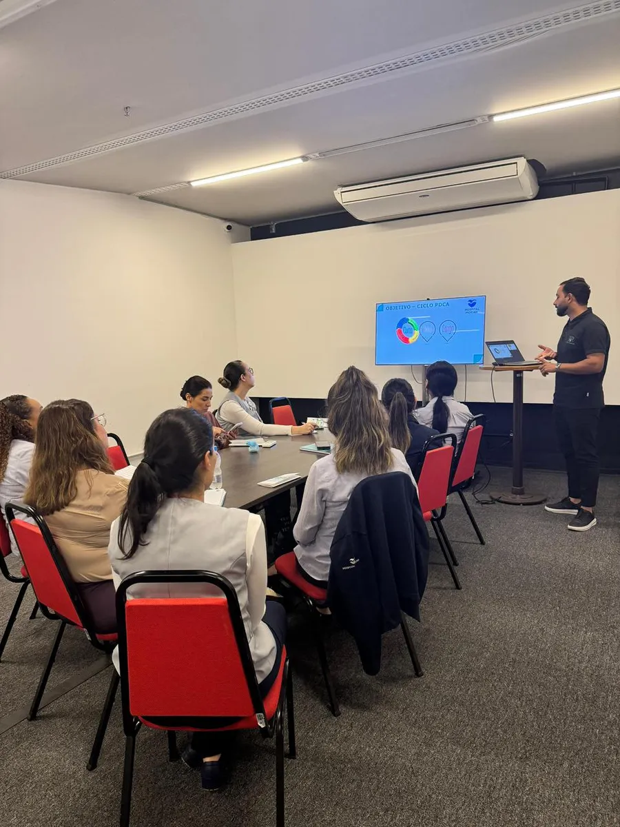 Especialista da JSR conduzindo palestra com apresentação para equipe de saúde